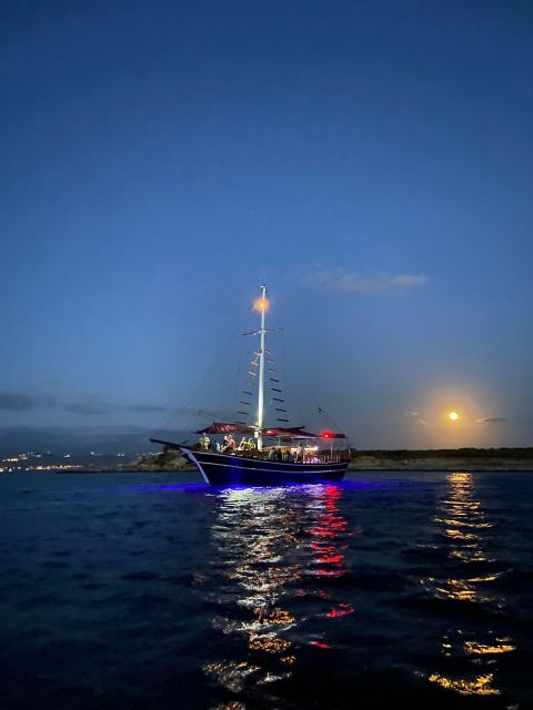 Argostoli: Sunset Cruise with Swim Stops, Dinner, and Wine - Sunset from the deck, then a darker return