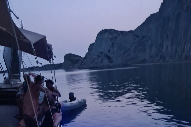 Dreamy Cruise sunset tour with dinner and unlimited wine! - Second stop: Xi Beach after dark