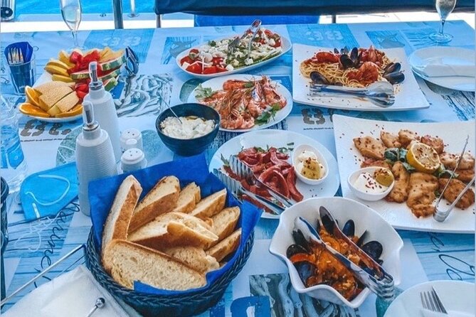 Half-Day Exclusive Catamaran Cruise in Santorini with Meal and Open Bar - Thirassia, snorkeling, and lunch on the boat