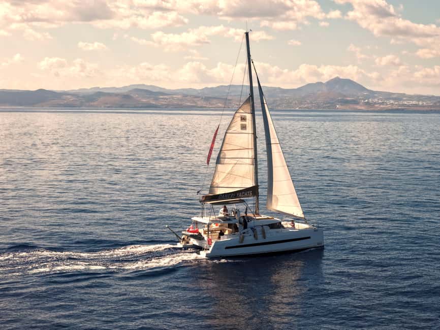 Hersonissos: Sunset Catamaran Cruise with Snacks and Drinks - Agios Georgios Bay, the active part of the evening