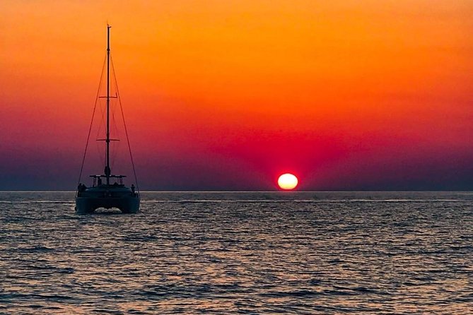 Luxury Small-Group Catamaran Cruise with BBQ, Open bar & Transfer - Thirasia and the caldera from sea level