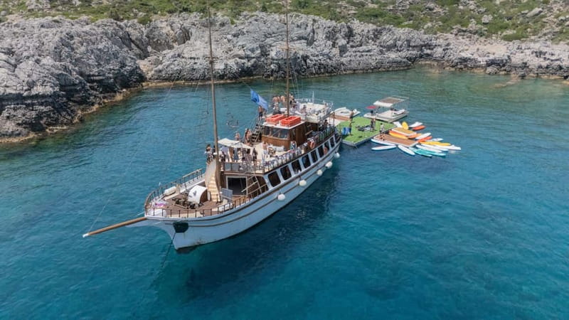 Rhodes: Gulet Trip with Food, Drinks, SUP, Kayak & Swimming - Greek lunch, fruit, and drinks on board