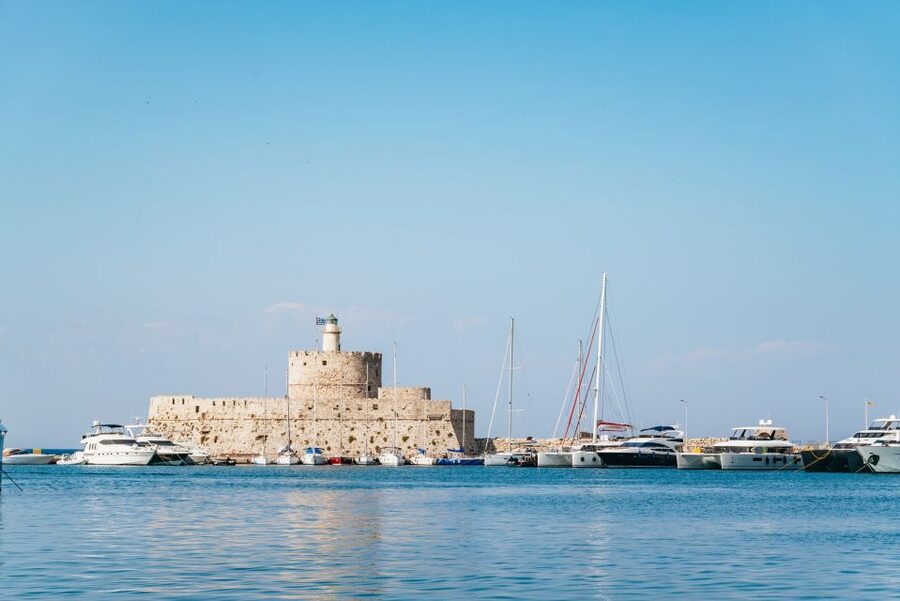 Rhodes: Sunset Catamaran Cruise with Dinner Buffet & Drinks - Sunset on the return to Rhodes Town