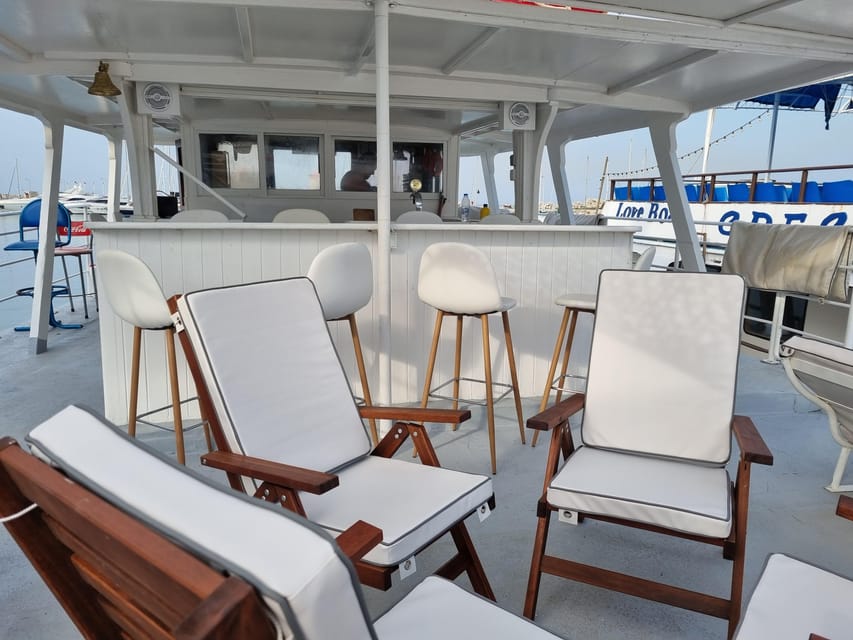 Rhodes: Sunset Cruise with Live Music, Wine & Greek Buffet - Leaving Mandraki Port With Rhodes in View
