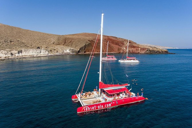 Sailing Catamaran Cruise in Santorini with BBQ, Drinks and Transfer - Sailing past the volcano and Palea Kameni