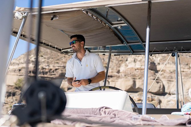 Santorini All-inclusive Catamaran Cruise with Thirassia Stop - The volcanic coast, lighthouse, and beaches