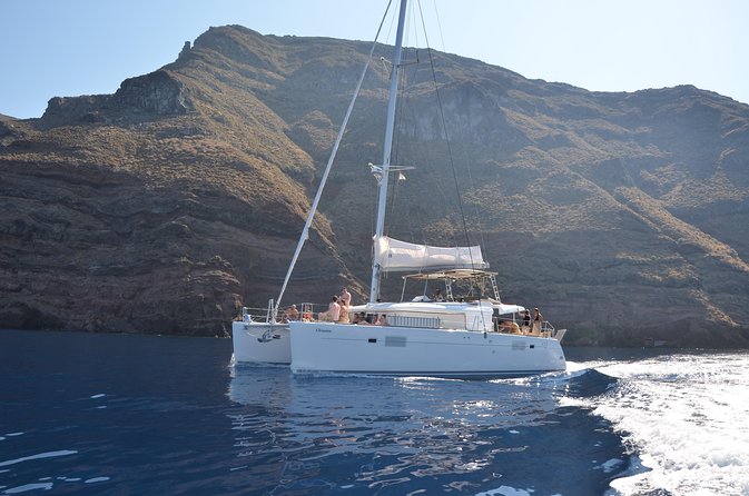 Santorini Caldera Gold Day Cruise with BBQ on board and Open Bar - White Beach, the lighthouse, and Black Mountain