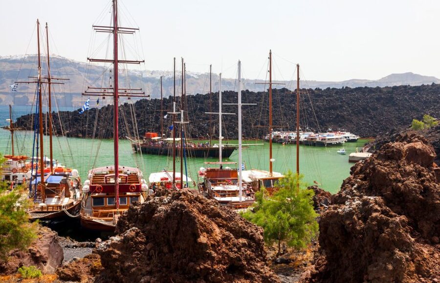 Santorini Caldera: Sunset Cruise with Dinner - Sailing below Oia’s cliffs