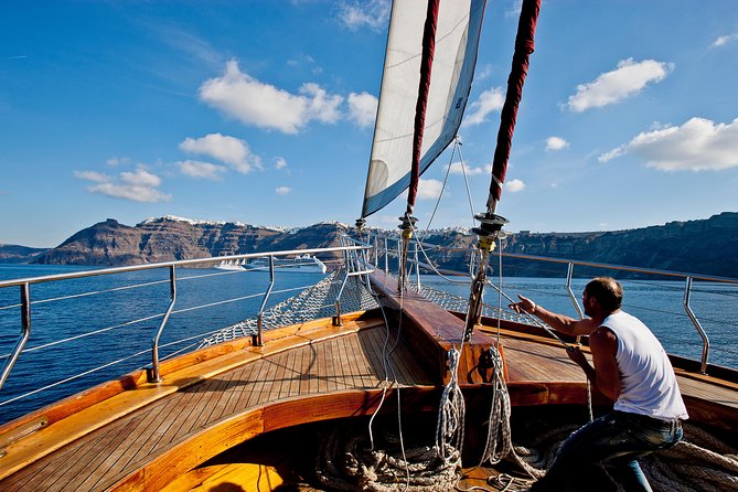 Santorini Caldera Sunset Sailing Cruise with Dinner and Wine - Sunset near Oia, seen from the sea