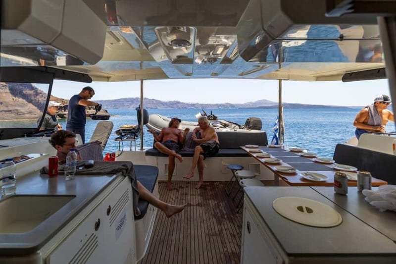 Santorini: Catamaran Cruise with Fresh Meal & Open Bar - Catamaran comfort, crew service, and group atmosphere