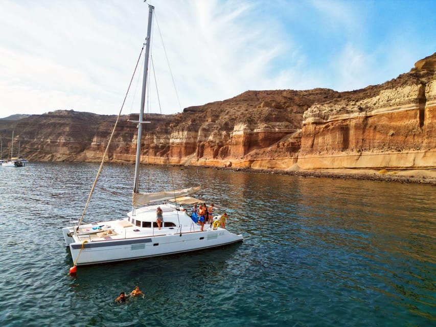 Santorini: Catamaran Cruise with Greek BBQ and Drinks - Red Beach: Santorini’s volcanic opening act
