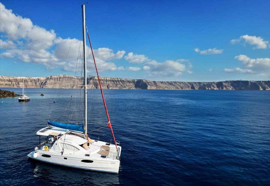 Santorini: Catamaran Cruise with Greek BBQ and Drinks - White Beach and the sea caves