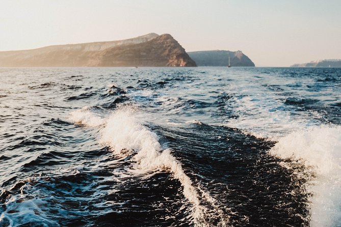 Santorini Private Catamaran Cruise with BBQ, Open Bar & Transfers - Indian Rocks, the lighthouse, and the caldera view
