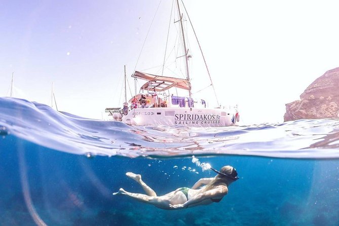 Santorini Private Catamaran Cruise with BBQ, Open Bar & Transfers - Red Beach and the iron-colored coast