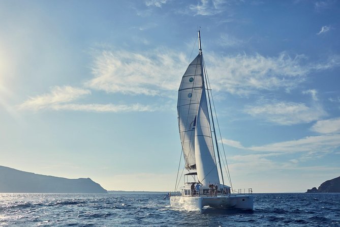 Santorini Sunset Luxury Sailing Catamaran Cruise with BBQ, drinks, transfer - White Beach and a Greek meal cooked on board